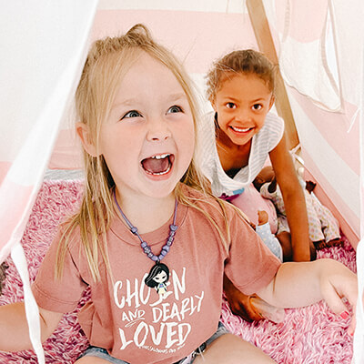 Two girls playing in the tent