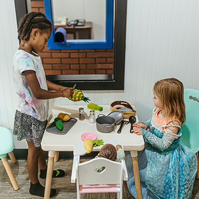 Two girls pretend cooking